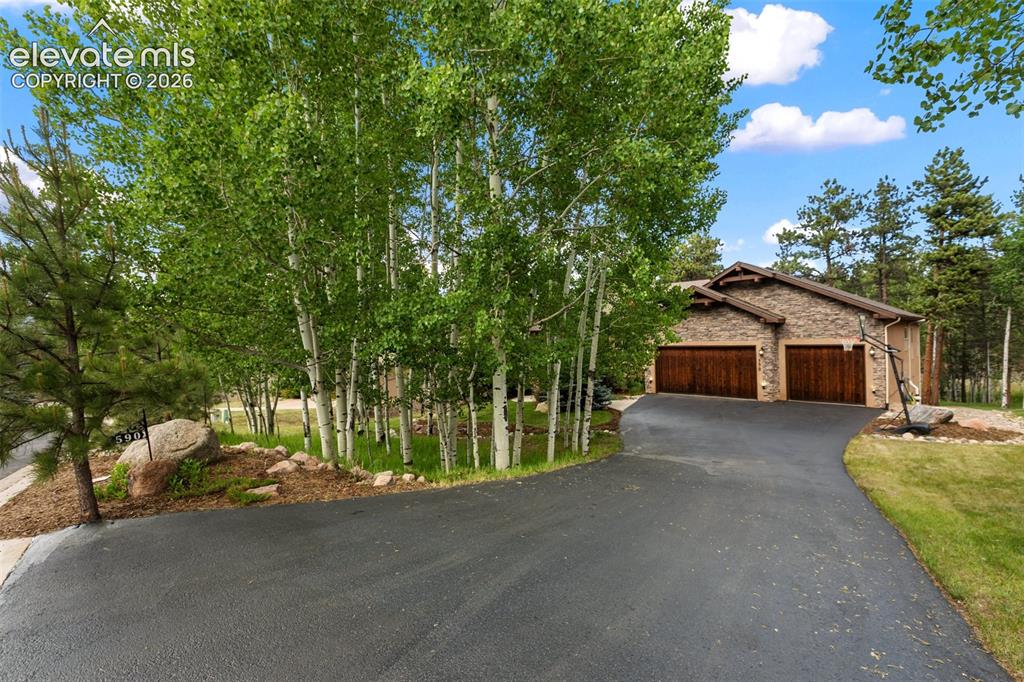 Image 45 of 50: South facing asphalt driveway which melts away light snowfalls in the winte