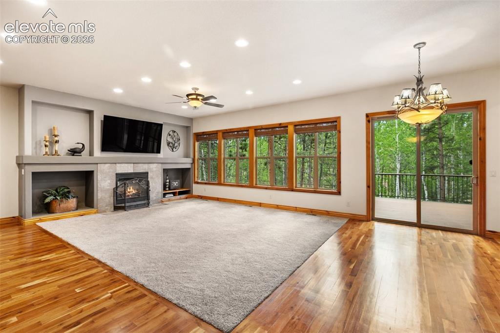Image 6 of 50: The wall of Craftsman-inspired mullioned windows brings the beauty of the f