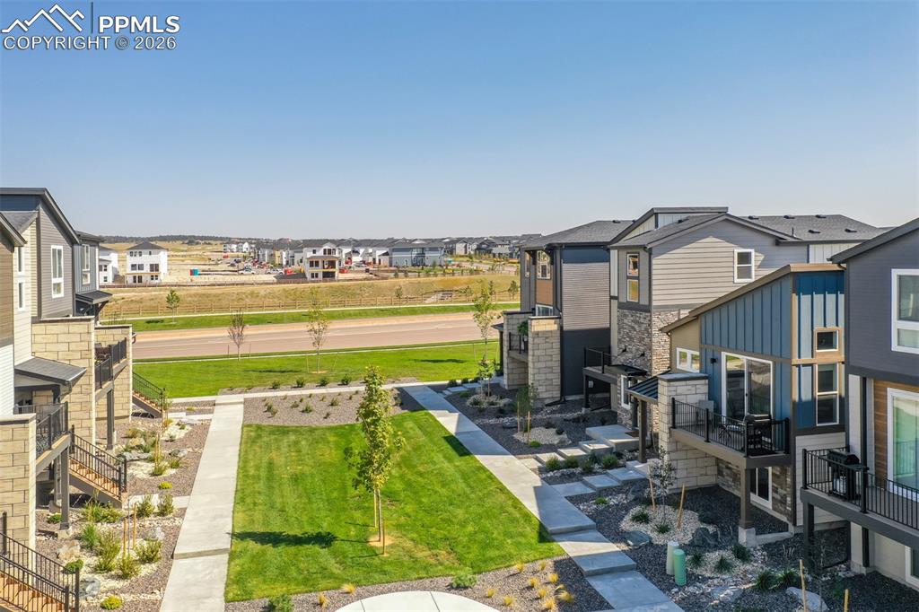 Image 37 of 46: View of grassy yard with a residential view and stairs