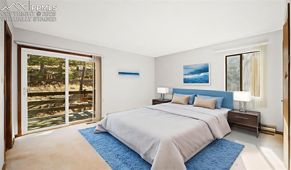 Image 20 of 50: Carpeted bedroom with access to outside, virtually staged