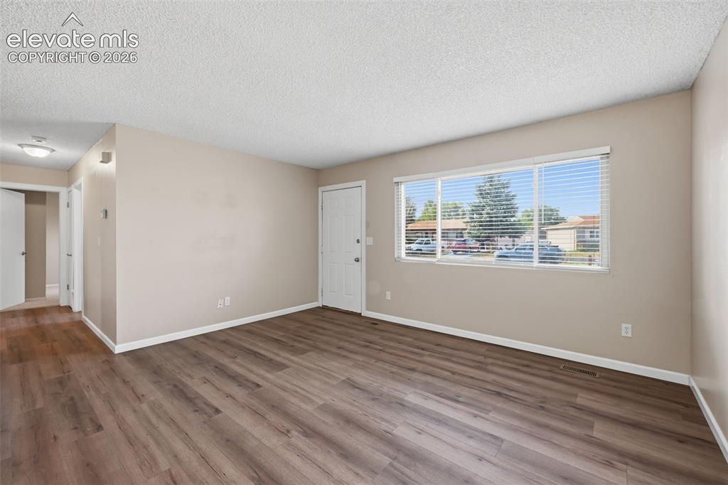 Image 17 of 36: Wood-finish flooring, white tile flooring, ceiling fan, sliding glass door,