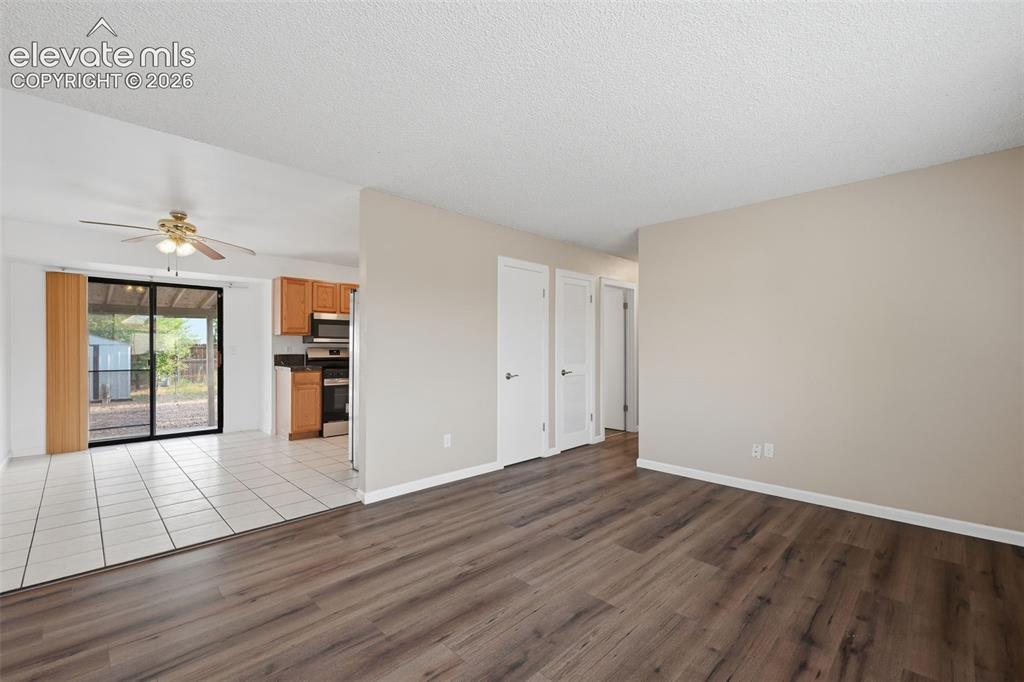 Image 18 of 36: Kitchen featuring wood-finish cabinetry, dark countertops, stainless steel