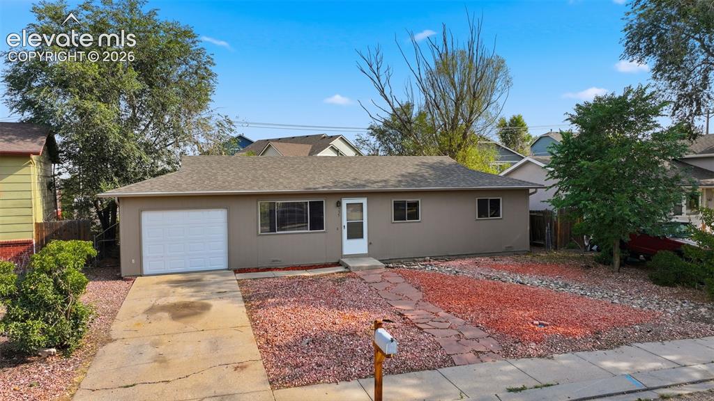 Image 2 of 36: Ranch-style exterior with a gabled roof, attached garage, and a concrete dr