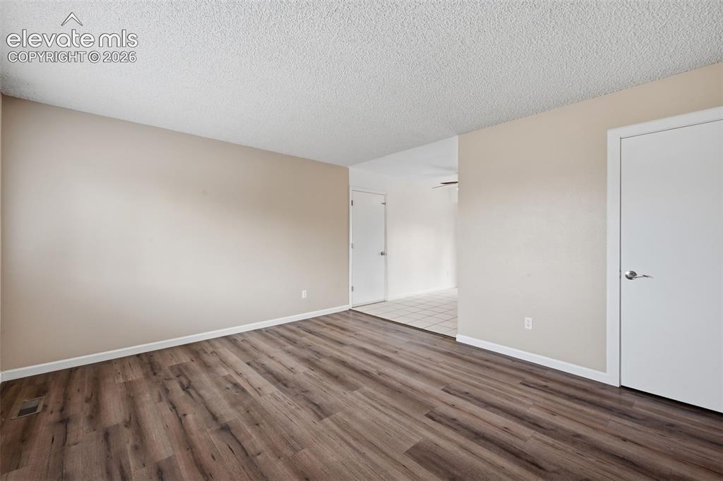 Image 24 of 36: Neutral-toned walls with textured carpeting