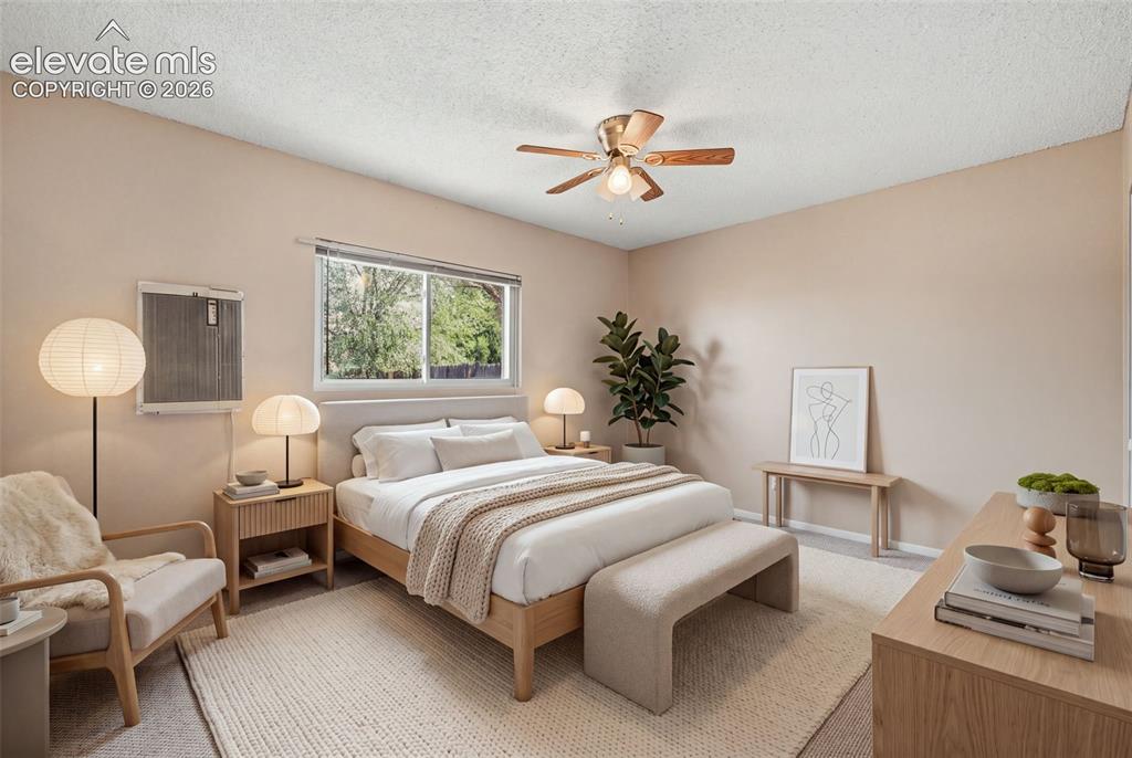Image 26 of 36: Neutral tone wall paint, textured ceiling, ceiling fan with integrated ligh
