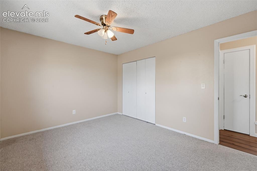 Image 27 of 36: Textured carpeting with light-toned walls