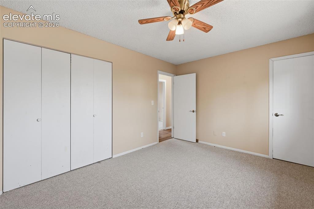 Image 28 of 36: Neutral-toned walls complement the light-colored carpeting