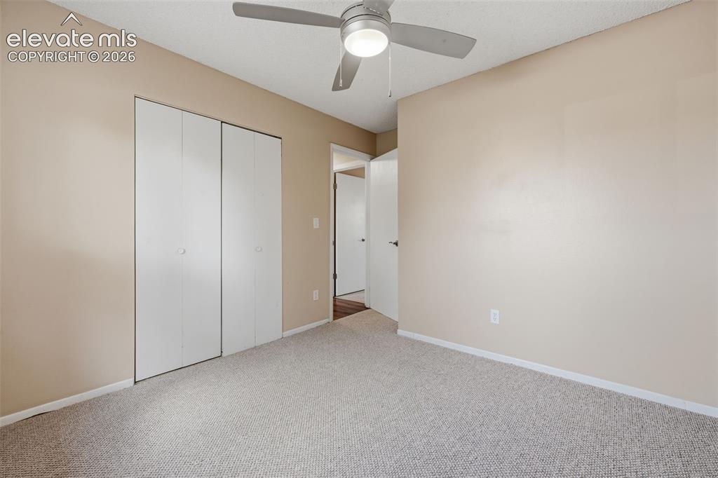 Image 31 of 36: Neutral-toned walls with a window featuring horizontal blinds