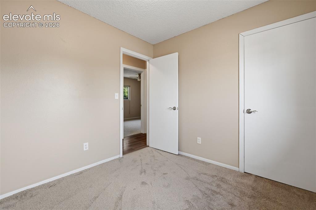 Image 33 of 36: Wood-finish flooring with a white vanity featuring an integrated sink, brus