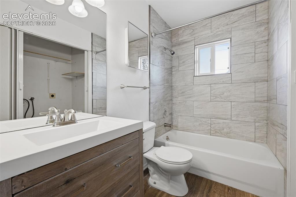 Image 34 of 36: Garage space featuring built-in cabinetry, a utility sink, overhead shelvin