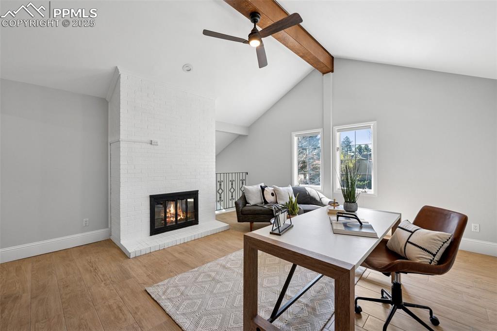 Image 27 of 48: Office featuring wood finished floors, a ceiling fan, baseboards, lofted ce