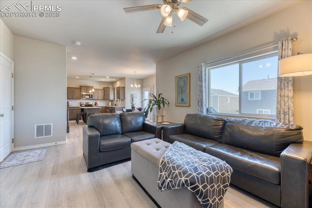 Image 14 of 39: Living area featuring healthy amount of natural light, light wood-style flo