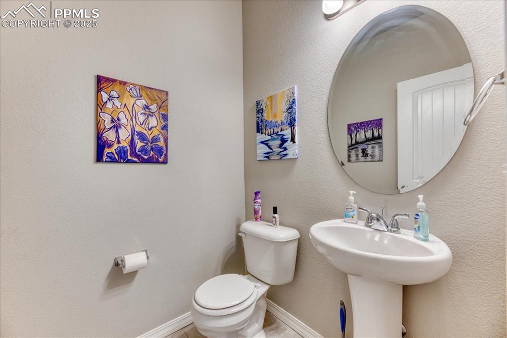 Image 15 of 39: Bathroom featuring toilet and baseboards