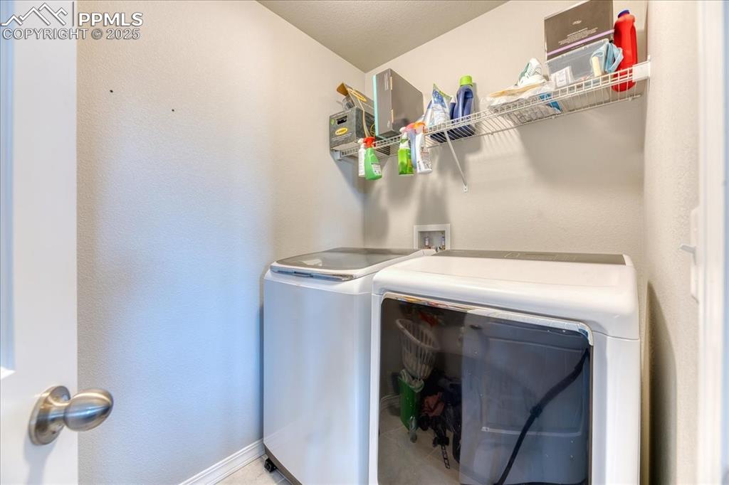 Image 19 of 39: Laundry room featuring washer and dryer and baseboards