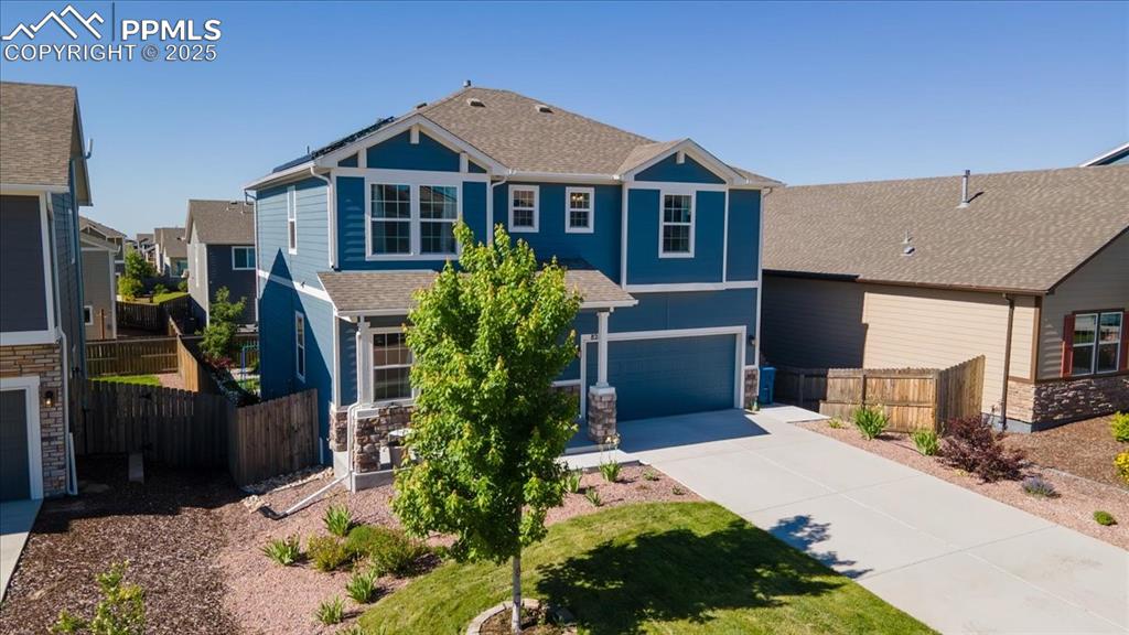 Image 3 of 39: View of front facade featuring driveway, a garage, roof with shingles, and 