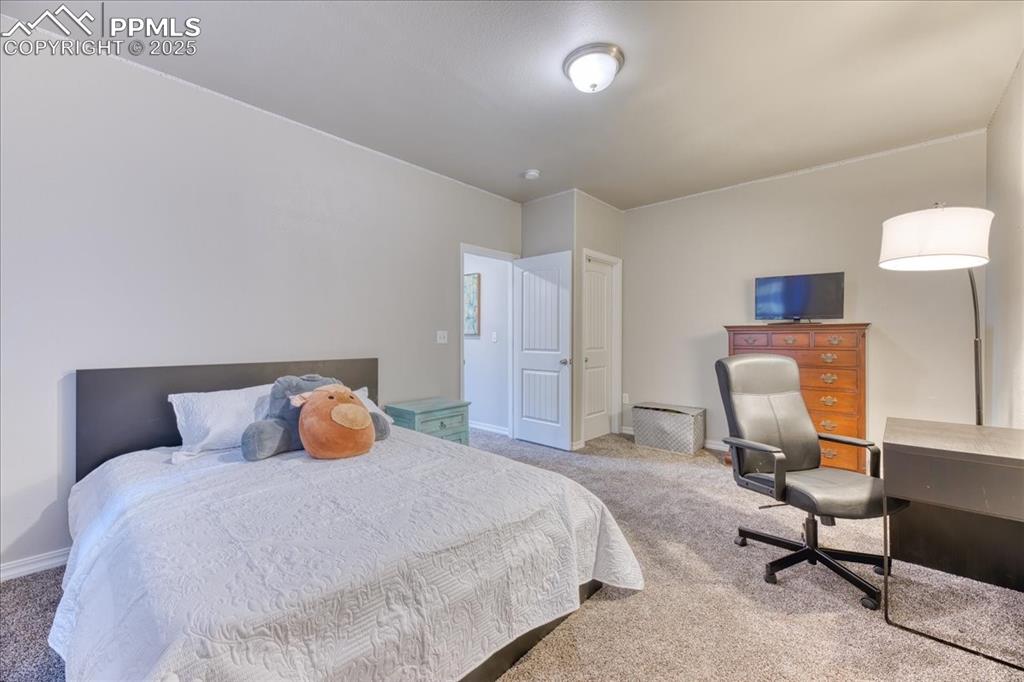 Image 30 of 39: Bedroom with carpet flooring and an office area