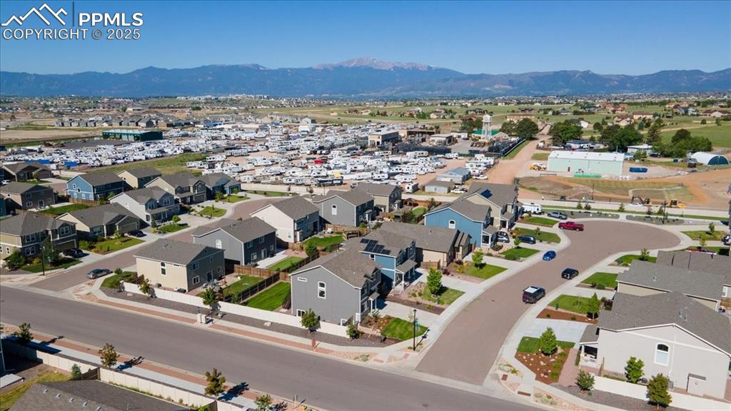 Image 37 of 39: Aerial perspective of suburban area with mountains