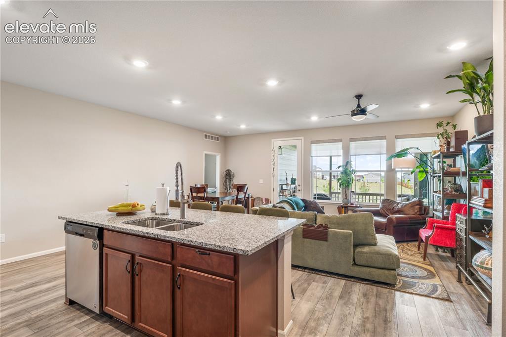 Image 10 of 38: Kitchen island with granite-style countertop, undermount double-basin sink,