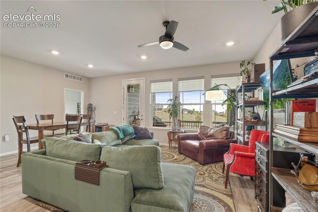 Image 13 of 38: Open-concept living area featuring a ceiling fan with integrated lighting, 