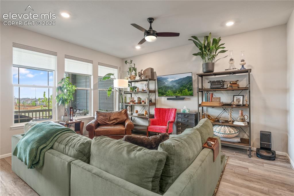Image 14 of 38: Living area featuring wood-finish flooring, recessed lighting, and a ceilin