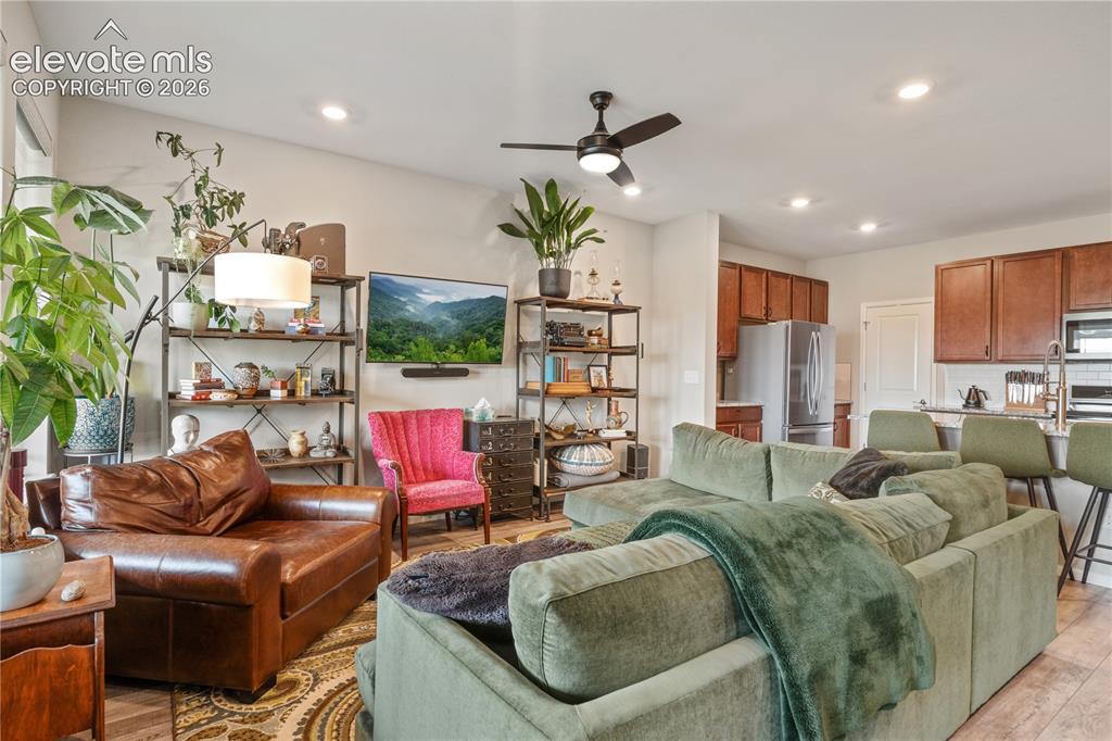 Image 15 of 38: Open-concept living space featuring vaulted ceilings, recessed lighting, an