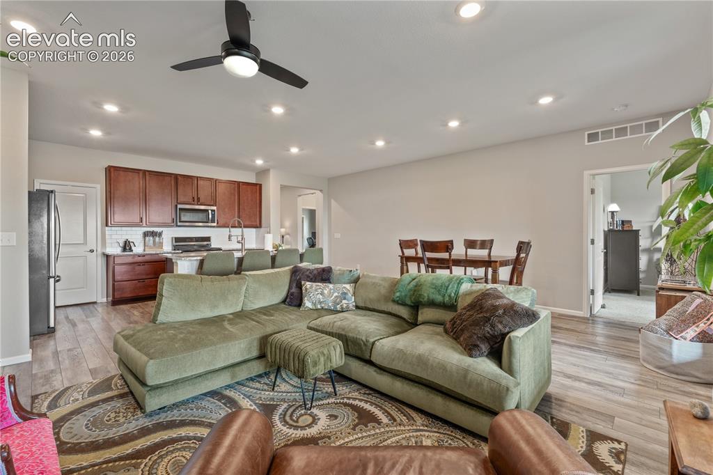 Image 16 of 38: Open-concept living space featuring wood-finish flooring and recessed light