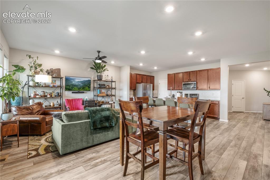 Image 18 of 38: Open-concept living space featuring wood-finish flooring, recessed lighting