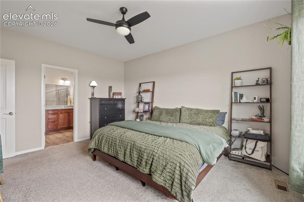 Image 20 of 38: Carpeted bedroom featuring a black ceiling fan with integrated lighting, ne
