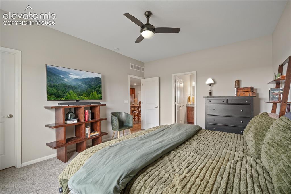 Image 21 of 38: Vaulted ceiling with a ceiling fan, light gray wall paint, and gray carpet 