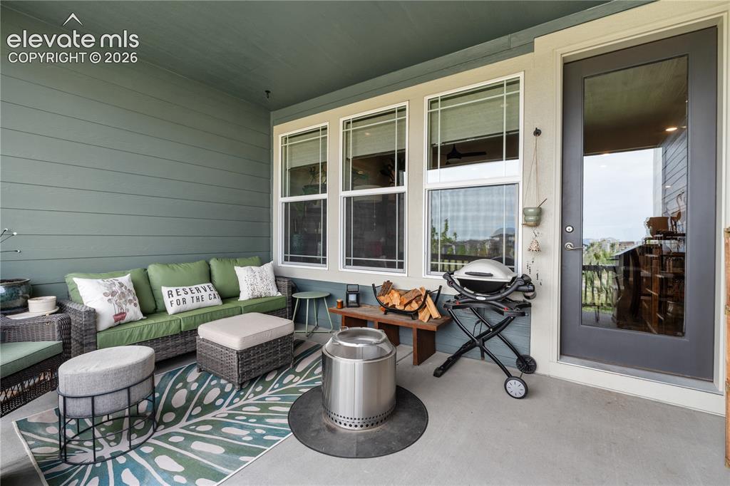 Image 32 of 38: Covered outdoor patio with a concrete surface, horizontal siding, and multi