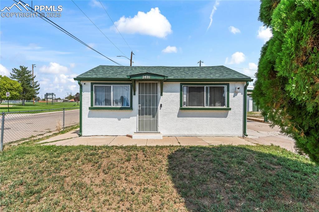 Image 2 of 26: View of front of home featuring stucco siding, roof with shingles, and a pa
