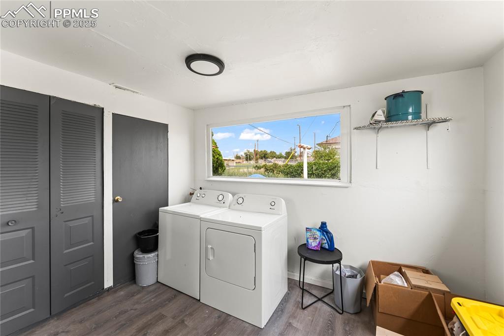 Image 21 of 26: Laundry room with dark wood-type flooring and washing machine and dryer