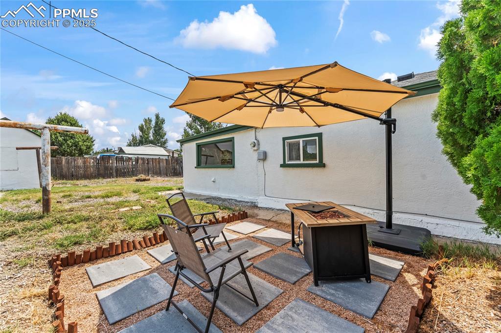Image 23 of 26: View of patio / terrace featuring an outdoor fire pit