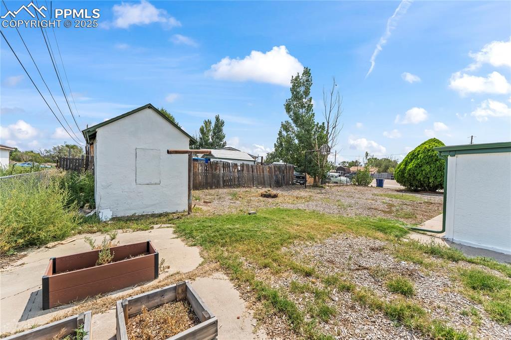 Image 26 of 26: View of yard featuring a garden and an outdoor structure