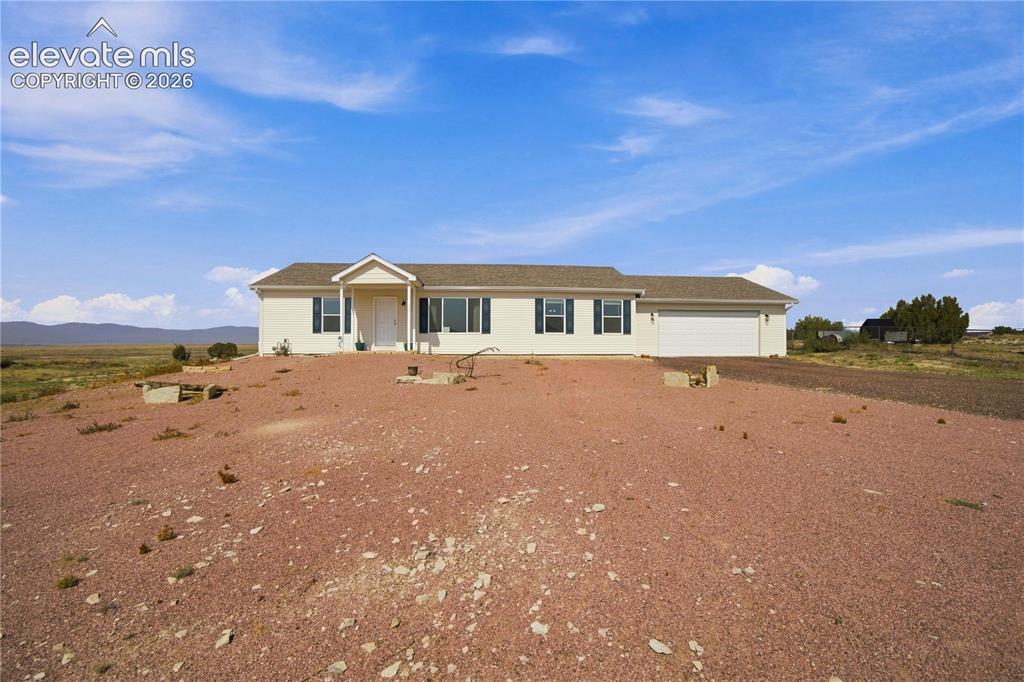 Caption: Spacious manufactured home situated on expansive grounds with open vistas across the property