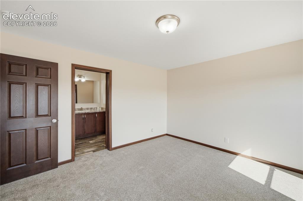 Image 11 of 26: Neutral wall color, carpeted flooring, paneled interior doors, flush mount