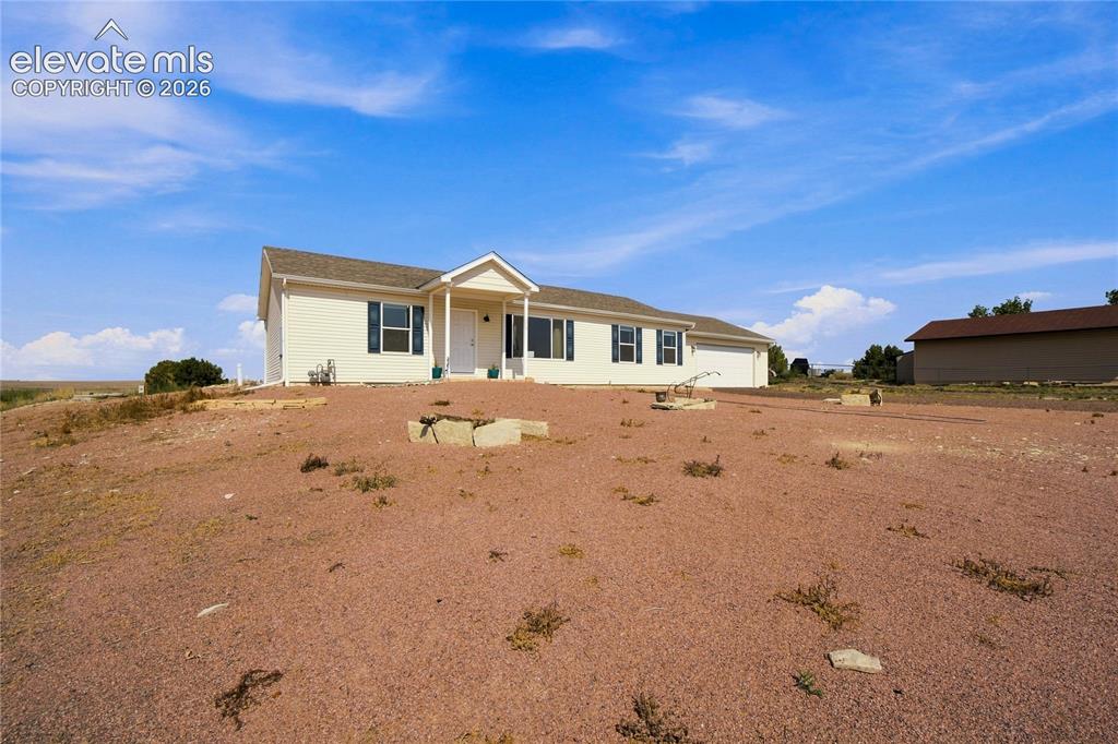 Image 20 of 26: Single-story residence featuring a covered front entry and attached garage