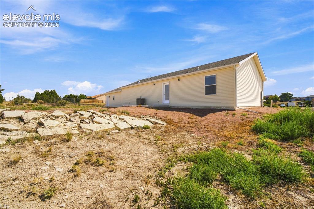 Image 24 of 26: Spacious manufactured home situated on expansive rural grounds with clear s