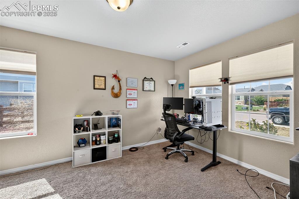 Image 18 of 33: Office area featuring light colored carpet and baseboards