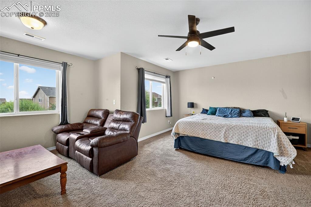 Image 20 of 33: Carpeted bedroom featuring baseboards and a ceiling fan