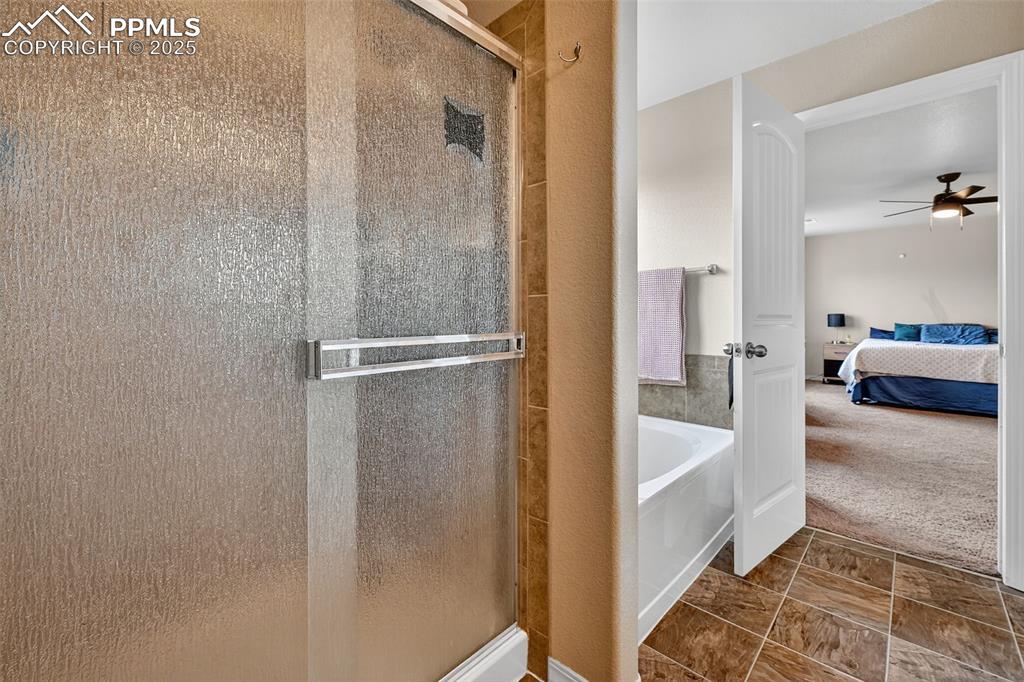 Image 24 of 33: Ensuite bathroom with a shower stall, a garden tub, and ceiling fan