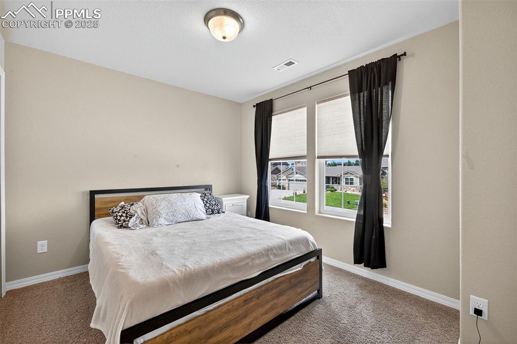 Image 28 of 33: Carpeted bedroom with baseboards
