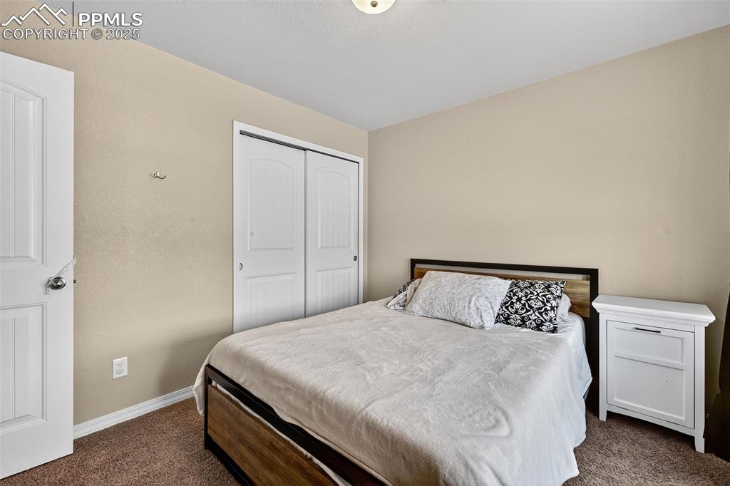 Image 31 of 33: Bedroom featuring dark colored carpet and a closet