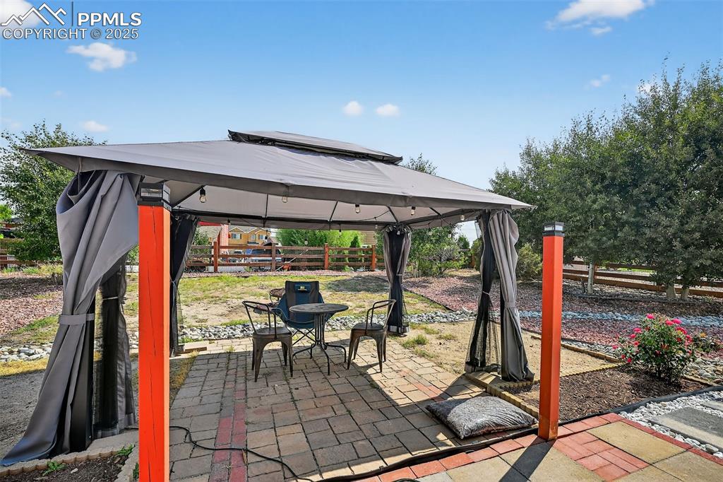 Image 4 of 33: View of patio featuring a gazebo