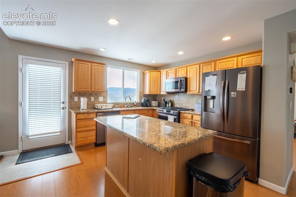 Image 10 of 46: Kitchen with walk out deck - main floor