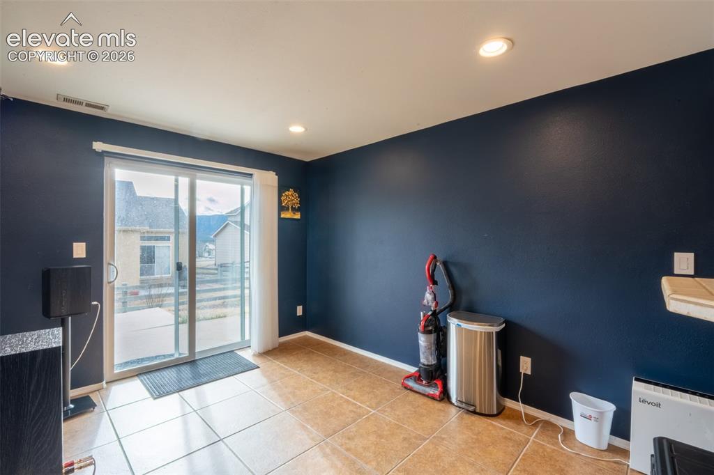 Image 35 of 46: Walk out basement door off wet bar and living room/home theater - basement