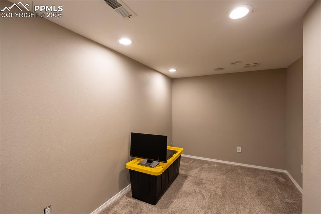 Image 37 of 45: Bonus room/non-conforming bedroom with storage room