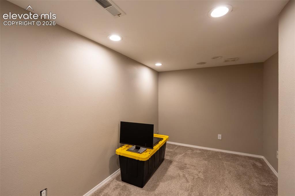 Image 38 of 46: Bonus room/non-conforming bedroom with storage room