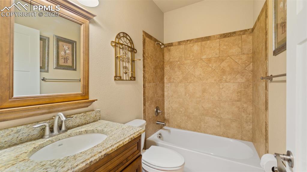 Image 16 of 50: Bathroom featuring vanity and bathing tub / shower combination