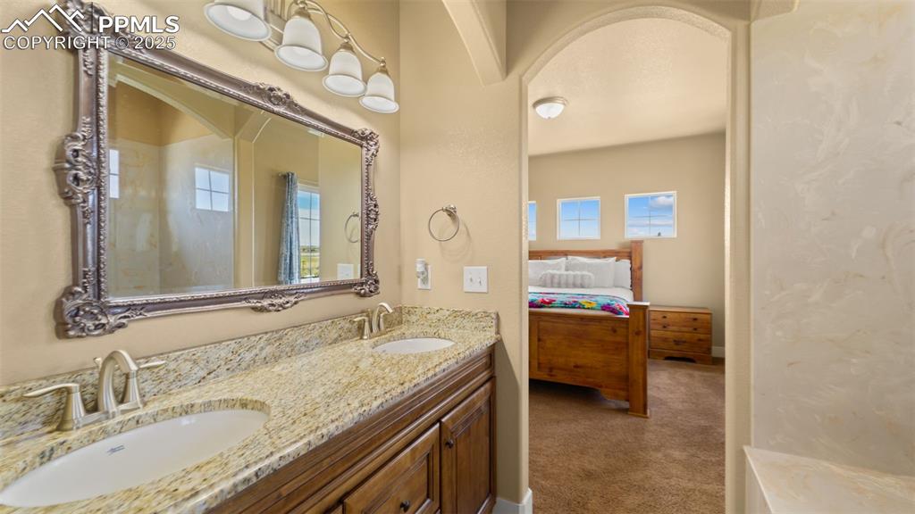 Image 21 of 50: Full bath featuring ensuite bathroom and double vanity